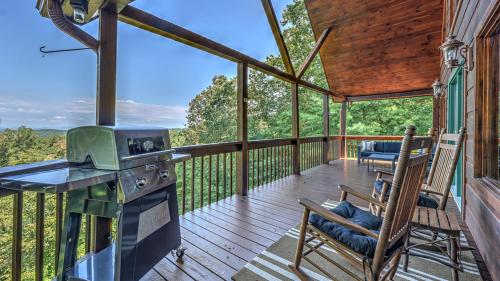 a screened in porch with a stove and chairs at Finding Grace in Blue Ridge