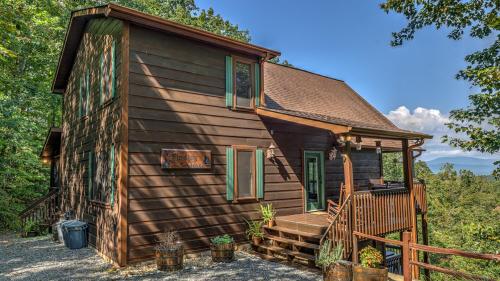 a small log cabin with a porch and a deck at Finding Grace in Blue Ridge