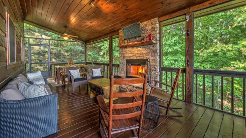 a screened in porch with a fireplace and a couch at Finding Grace in Blue Ridge