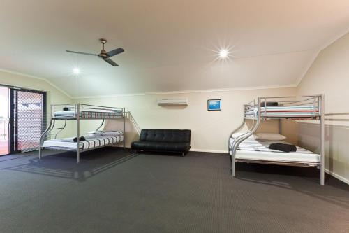 a room with three bunk beds and a ceiling at 3 Kestrel Place in Exmouth