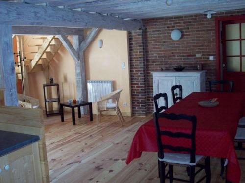 une pièce avec une table et des chaises et un mur de briques dans l'établissement Maison de campagne rénovée avec jardin privatif - 2 chambres, 2 sdb, séjour spacieux - FR-1-590-105, à Douchy