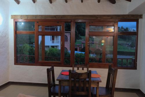 a dining room with a table and a window at Hospedaje Iraca - Pueblito Boyacense Duitama in Duitama