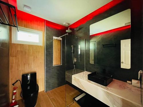 a bathroom with a sink and a mirror at Private Pattaya Resort in Nong Prue
