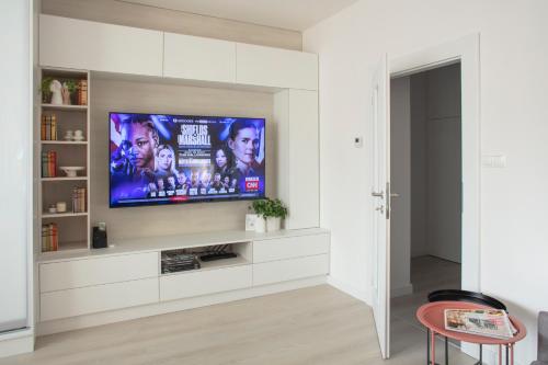 a living room with a flat screen tv on a wall at Light Room by Zoom Apartments in Bratislava