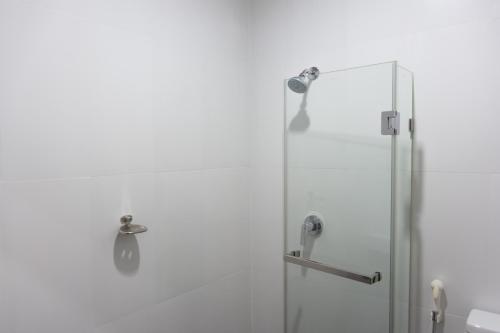 a shower with a glass door in a bathroom at Mayflower Grand Hotel Korat in Nakhon Ratchasima