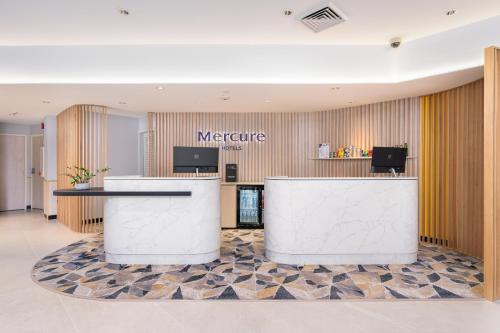 a lobby of a hotel with a reception counter at Mercure Rockhampton in Rockhampton