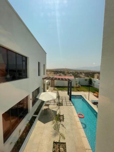 a view of a house with a swimming pool at Lammah chalet in Muscat