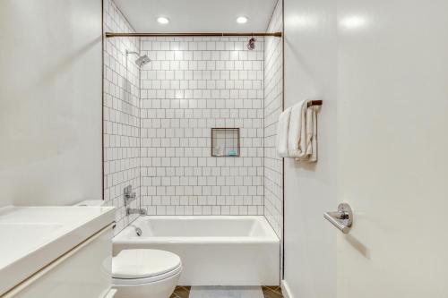 a white bathroom with a tub and a toilet at Portland Blues in Portland