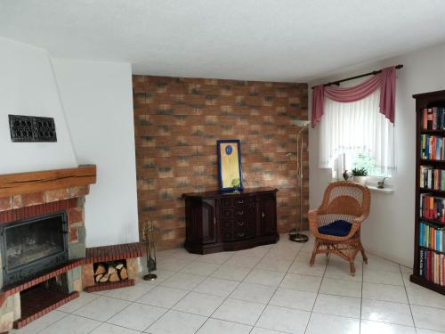 a living room with a brick wall and a fireplace at Ferienhaus Frank in Potzlow