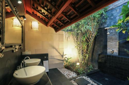 a bathroom with a sink and a toilet in it at Scallywags Mango in Gili Islands