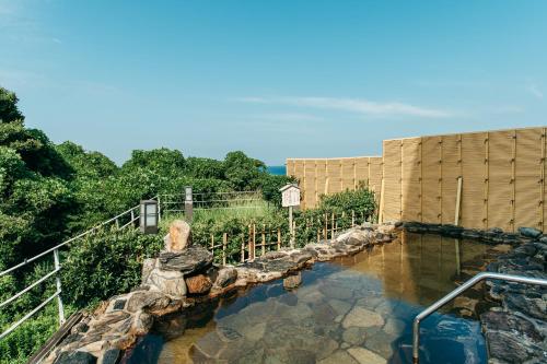 a pool of water in front of a building at KAMENOI HOTEL Genkainada in Kitakyushu