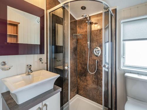 a bathroom with a sink and a shower at Links Lodge in Grange Over Sands