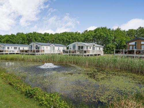 a pool of water with houses in the background at Links Lodge in Grange Over Sands
