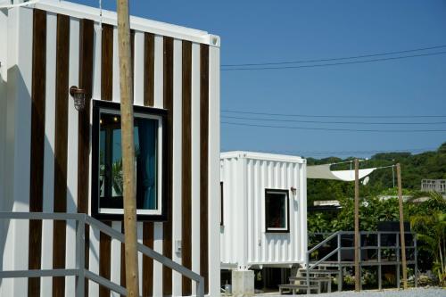 a small white building with a fence next to it at Vacation Village Okinawa - Nakijin in Nakijin