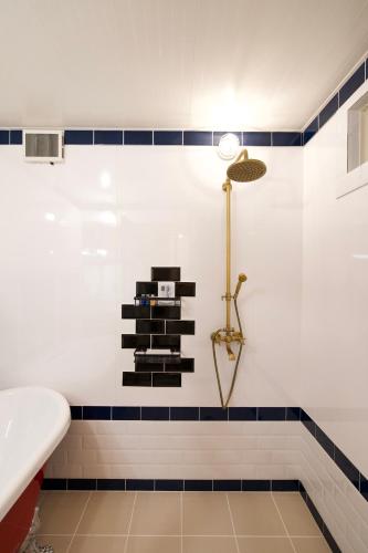 a bathroom with a tub and a sink at Vacation Village Okinawa - Nakijin in Nakijin