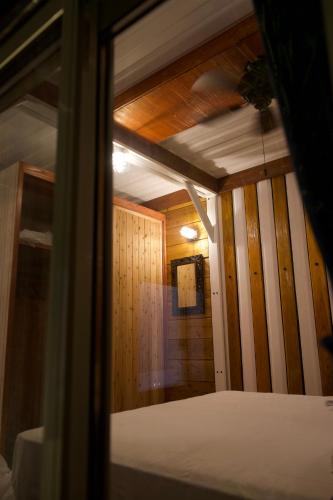 a room with a bed in a room with wooden walls at Vacation Village Okinawa - Nakijin in Nakijin