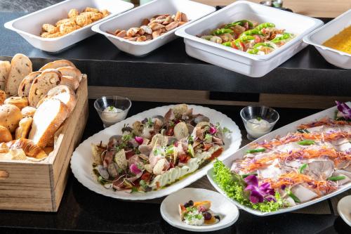 a buffet of different types of food on a table at Hotel Vista Fukuoka Nakasu-Kawabata in Fukuoka