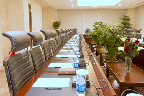 a long table with chairs in a conference room at Mariana Hotel Erbil in Erbil