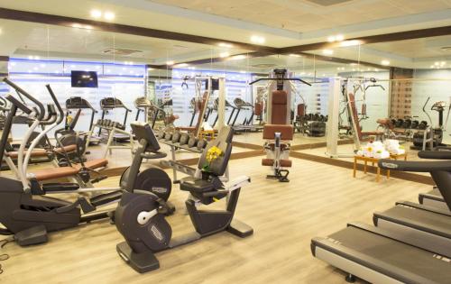a gym with treadmills and elliptical machines at Mariana Hotel Erbil in Erbil