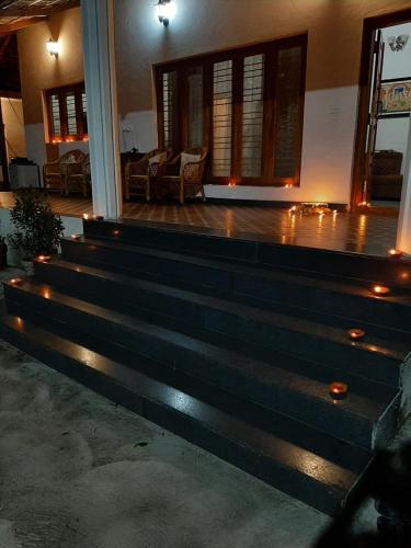 a set of stairs in a house with lights at Katihalli Estate Stays in Hassan