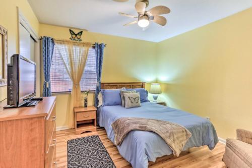 a bedroom with a bed and a flat screen tv at Peaceful Fresno Home, Near Popular Wineries! in Fresno