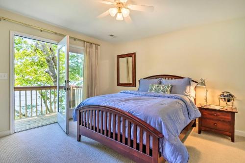 a bedroom with a bed and a sliding glass door at Ideal Chickamauga Lake Home and Dock and Fire Pit in Soddy-Daisy