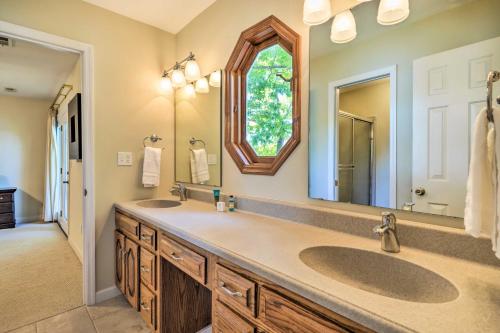 a bathroom with two sinks and a large mirror at Ideal Chickamauga Lake Home and Dock and Fire Pit in Soddy-Daisy
