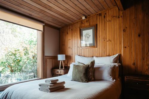 a bedroom with a large bed with a window at Kangaroo Manor in Yarra Junction