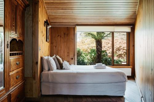 a bedroom with a bed and a large window at Kangaroo Manor in Yarra Junction