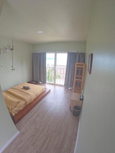 a bedroom with a bed and a window and a ladder at WHITE SAND ARK RESORT in Koh Rong Island