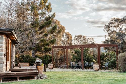 a gazebo with a table and chairs in a yard at Kangaroo Manor in Yarra Junction