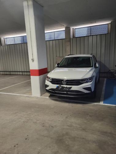 a white car parked in a parking garage at Alazán Jerez II-Parking gratis-wifi in Jerez de la Frontera