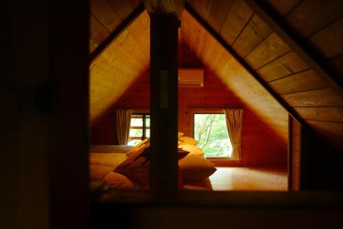 a view of a bedroom in a log cabin at Kurasako Onsen Sakura in Minamioguni