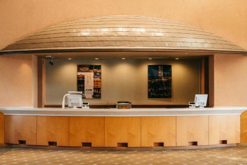 a large lobby with a counter in a building at KAMENOI HOTEL Genkainada in Kitakyushu