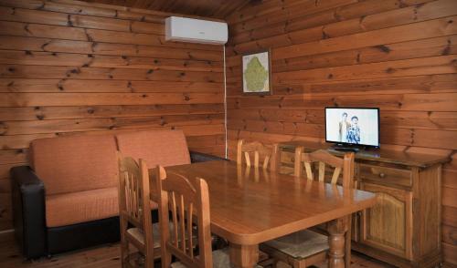 a dining room with a table and a computer on it at El Llano de los Conejos Serranía de Cuenca in Cañamares
