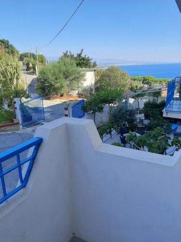 a white balcony with a view of the ocean at Hotel Conca d'Oro in Stalettì
