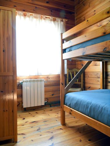 a bedroom with a bunk bed and a window at El Llano de los Conejos Serranía de Cuenca in Cañamares