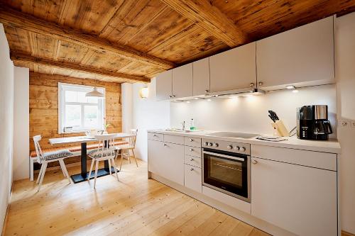 a kitchen with a table and a dining room at Gutshof Schirgiswalde in Schirgiswalde