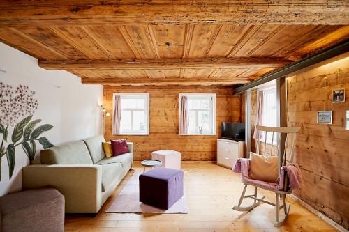 a living room with a couch and a tv at Gutshof Schirgiswalde in Schirgiswalde