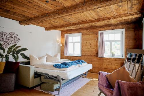 a bedroom with a bed in a room with wooden walls at Gutshof Schirgiswalde in Schirgiswalde