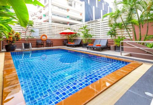a swimming pool on top of a building at FuramaXclusive Sukhumvit in Bangkok