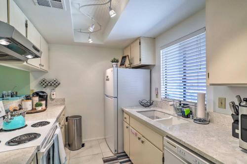 a kitchen with a refrigerator and a sink at Golf Course View and Pool Access Palm Desert Home in Palm Desert