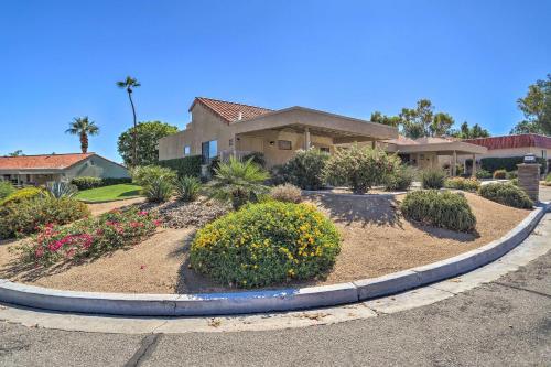 a house with a landscaping in front of a driveway at Golf Course View and Pool Access Palm Desert Home in Palm Desert