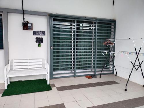 a room with a white bench and a large window at WAFID HOMESTAY SERI ISKANDAR in Seri Iskandar
