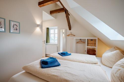 a bedroom with two beds with towels on them at Gutshof Schirgiswalde in Schirgiswalde