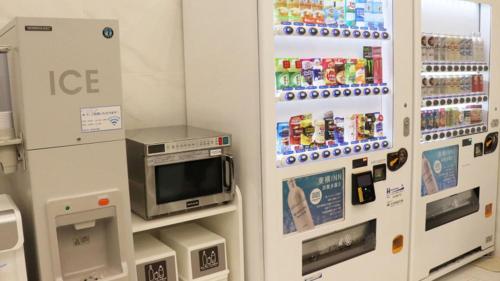 a convenience store with two ice machines in a store at Toyoko Inn Kita-asaka-eki Nishi-guchi in Asaka
