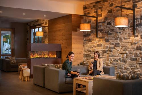 two women sitting on couches in a lobby at Sport Village Hotel & Spa in Castel di Sangro