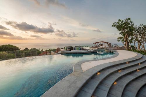a swimming pool with a view of the ocean at AYANA Segara Bali in Jimbaran