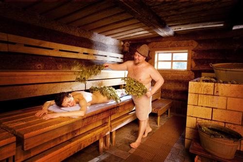 a man standing in a sauna with a woman at Park-Hotel am Rhein - Gesundheitshotel und Residenzen in Rheinfelden