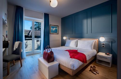 a bedroom with a large bed with a red pillow at Centro Storico in Neviglie